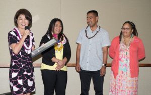 First Lady Dawn Amano-Ige prepares with Child Welfare Services staff to present Soares with a proclamation recognizing his journey to reunification. 