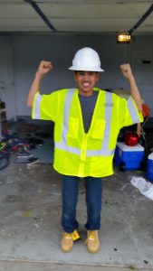 Intern for Hawai‘i county Environmental Management Department, Arnold Kahaunaele, smiles in his work uniform vest. “Arnold would sleep in that vest if we let him!” says his resource caregiver (foster mother). 